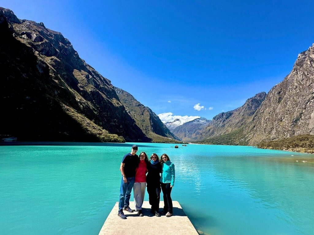 Llanganuco Lagoon tour Huaraz with tourists enjoying the turquoise glacial lake and mountain views